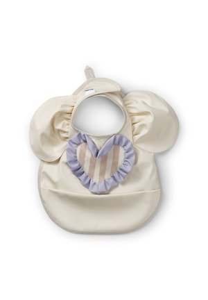 Bavaglino color crema con maniche increspate, decorato con un'applicazione a forma di cuore lilla con dettagli a righe. Materiale liscio e impermeabile. Chiusura del collo regolabile.