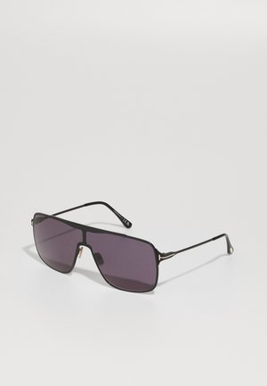 Lunettes de soleil rectangulaires noires avec des verres foncés et des branches fines et élégantes accentuées d'or. Présente un design de cadre géométrique audacieux.