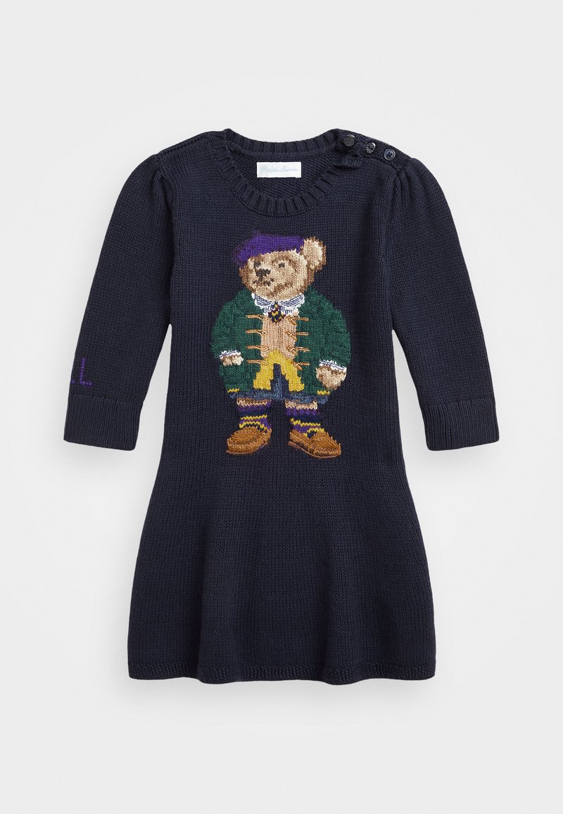 Knitted navy dress featuring a bear design. Long sleeves, round neck, and decorative buttons. Includes purple text detail on the sleeve.