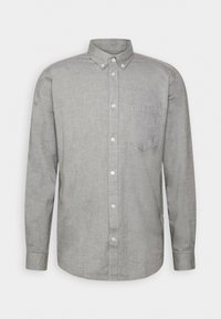 Chemise à manches longues boutonnée en tissu gris clair avec une texture subtile. Présente un col boutonné et une poche poitrine du côté gauche.