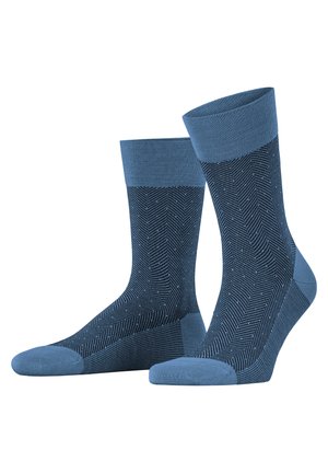 Blaue Socken mit Fischgrätenmuster, ausgestattet mit einem einfarbigen blauen Bündchen und Fußspitze. Hergestellt aus einem glatten, dehnbaren Material für zusätzlichen Komfort.