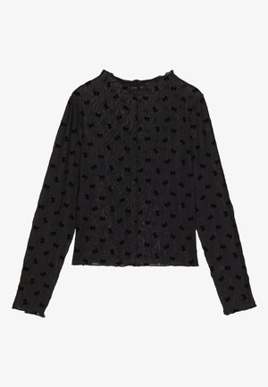 Haut noir à manches longues en tissu texturé, avec un design ondulé et des motifs de nœuds surélevés partout. Encolure arrondie et silhouette ajustée.