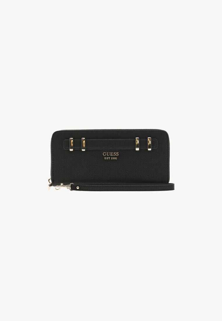 Black Guess zip-around wallet with gold-tone hardware, logo text "GUESS EST 1981," and detachable wrist strap.
