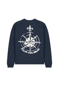 Felpa navy con collo rotondo, caratterizzata da un design a forma di bussola bianca e la scritta "SEGUI I TUOI SOGNI" sotto di essa. Tessuto morbido.
