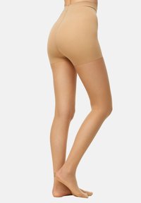 Bermudas moldeadoras beige sin costuras con una cinturilla alta, hechas de material elástico, con una textura suave y longitud a la mitad del muslo.