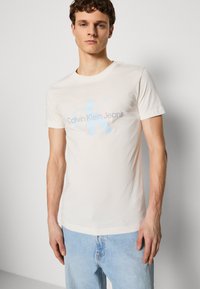 Calvin Klein Jeans SEASONAL MONOLOGO TEE - Marškinėliai su spaudiniu - ivory