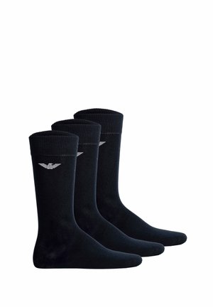 Drei Paar schwarze knielange Socken nebeneinander, jeweils mit einem kleinen weißen Logo nahe dem oberen Bündchen.