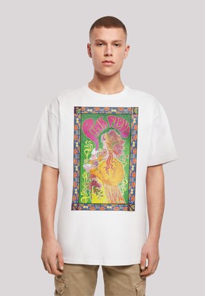 White cotton t-shirt featuring a vibrant Pink Floyd graphic with floral and psychedelic patterns in green, yellow, and pink colors.