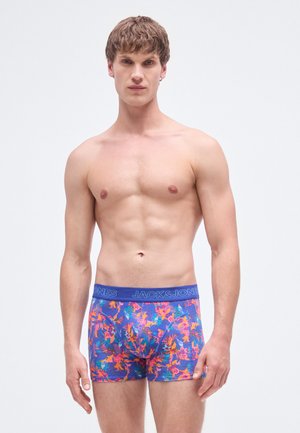 Men's floral boxer briefs featuring a blue waistband with "JACK & JONES" branding. Fabric displays vibrant floral patterns on a purple background.