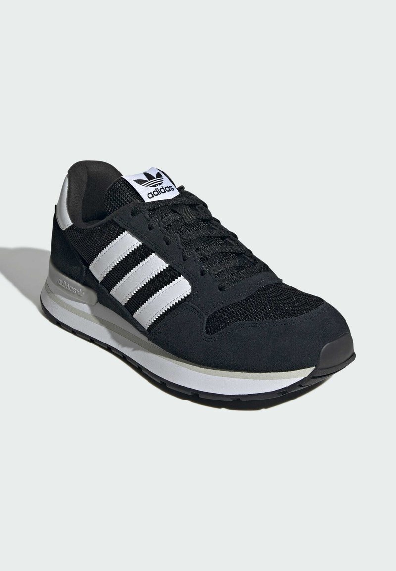 Black Adidas sneaker with white stripes, mesh toe, and cushioned sole, shown at a three-quarter angle on a light background.