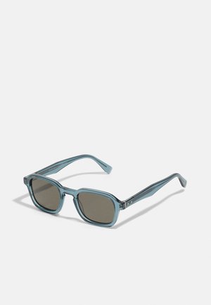 Blue plastic sunglasses with square frames, dark brown lenses, and sleek, angular arms. Features subtle pattern in the frame design.