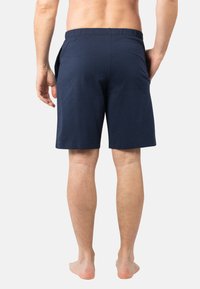 Shorts en coton bleu marine avec une taille élastique. Dotés de poches latérales. Design simple, coupe à mi-cuisse, texture lisse et sans motifs visibles.