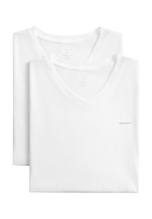 Two folded plain white V-neck T-shirts with a small "GANT" logo on the chest, stacked with one slightly behind the other.