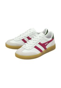 White sneakers with pink and green accents; rubber soles, suede toe caps, and classic lace-up design. Brand name "Gola" visible on the side.