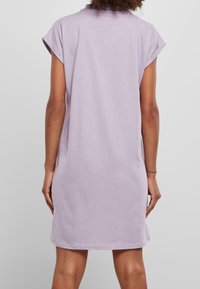 Kurzärmeliges Kleid aus leichtem Lavendeltuch, mit lockerem Schnitt, rundem Ausschnitt und Saum, der knapp über dem Knie endet. Sanfte Textur.