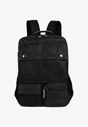 Sort lærredsrugtaske med flere lynlåslommer, justerbare polstrede stropper og et håndtag øverst. Har en glat tekstur og et slidstærkt design.