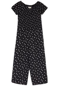 Combinaison noire à manches courtes, corsage froncé et pantalon large. Présente un motif à pois blancs sur l'ensemble. Texture de tissu douce.