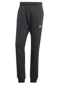 Pantaloni da jogger neri Adidas con cintura elastica, tasche laterali, caviglie elastiche e logo bianco Adidas sulla coscia sinistra.