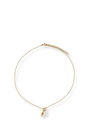 Delicate gold chain necklace with small charm featuring a gold eye shape and three white pearls on a white background.