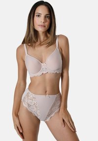 Beige Spitzen-BH mit Unterdraht und verstellbaren Trägern, kombiniert mit hochgeschnittenen Panties, die Spitzenakzente und ein zentrales Schleifendetail aufweisen.
