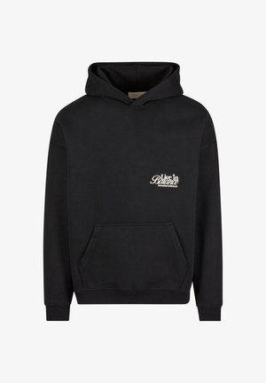 Sweatshirt noir avec une poche kangourou, des poignets et une taille côtelés. Présente un texte brodé blanc "Vivre en Équilibre" à l'avant. Tissu doux.