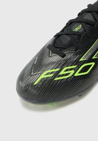 adidas Performance F50 ELITE UNISEX - Firm-ground football boots - core black/iron/lucid lemon