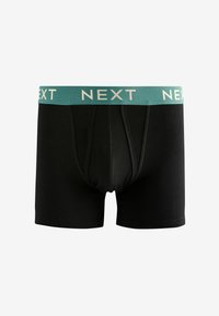 Črne bokserice z teal pasom, na katerem je v svetli pisavi napisan napis "NEXT". Material se zdi gladek z oprijetim prileganjem in sprednjim odprtjem.