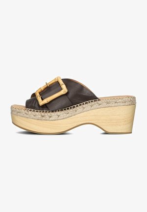 Brown leather platform sandals with a bamboo buckle, woven jute detailing, and a curved wooden sole. Smooth texture, casual design.