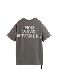Camiseta de algodón gris de manga corta que presenta el texto "MOVIMIENTO MOD WAVE" en letras blancas, en negrita y texturizadas, en la parte posterior.
