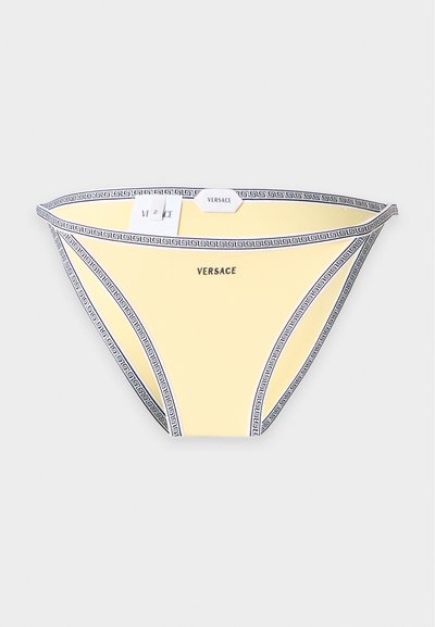Bas de bikini jaune Versace avec bordure noire motif clé grecque et logo Versace centré devant sur fond blanc.