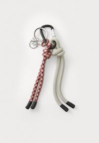 Keychain with two braided ropes: one gray and one patterned red and beige. Includes metal rings and a small decorative charm.