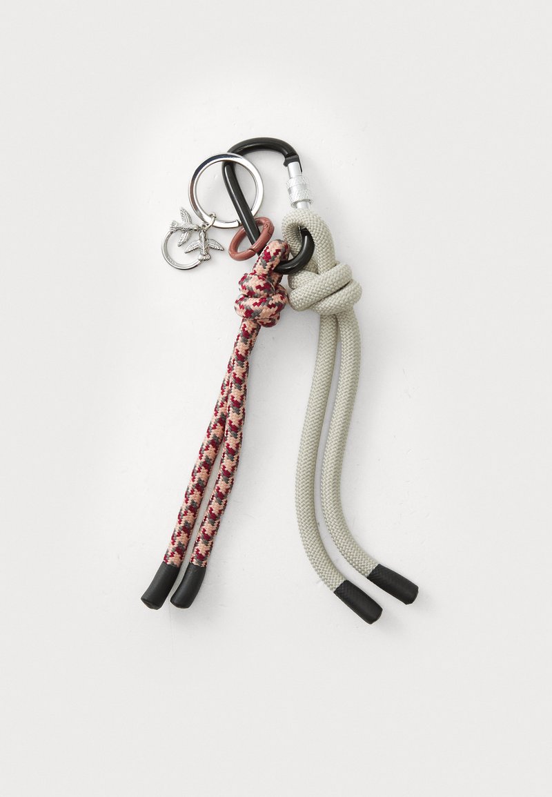 Keychain with two braided ropes: one gray and one patterned red and beige. Includes metal rings and a small decorative charm.