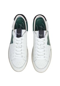 White leather sneakers with green accents, perforated toe, and black trim. Features flat laces and branded tags on the tongue.