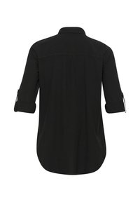 Chemise noire à manches longues avec manches retroussées, ourlet incurvé et un seul pli arrière sous le yoke, vue de dos.