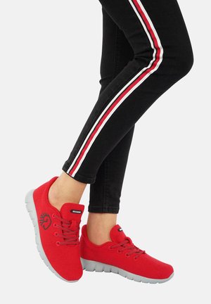 Red fabric sneakers with grey rubber soles, round toe, and decorative laces. Features a logo on the outer side and textured fabric.