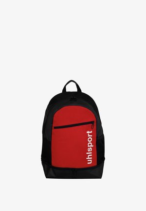 Sac à dos noir et rouge avec une poche avant à fermeture éclair, une poche latérale en filet, une poignée de transport et le logo blanc vertical "uhlsport" sur le panneau rouge.