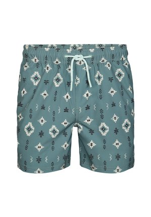 Blauwgroene zwembroek met witte en zwarte geometrische patronen en een lichtblauw trekkoord in de elastische tailleband.