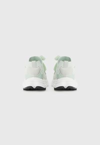 Light green sneakers featuring a mesh and fabric upper, white sole, and black outsole. Rear view showing pull tabs and accent details.