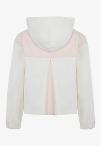 Giacca con cappuccio caratterizzata da un corpo crema con pannelli rosa sulle spalle. Progettata con polsini elasticizzati e una fessura posteriore per una migliore ventilazione.