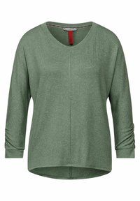 Grön långärmad topp med V-ringning, med rullade manschetter, sidsömsdetaljer och en avslappnad passform. Tillverkad av mjukt, texturerat tyg.