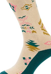 Nákolenky v béžové barvě s barevnými vzory v růžové, zelené a zlaté. Mají texturovaný úplet a kontrastní tyrkysové akcenty na manžetě.