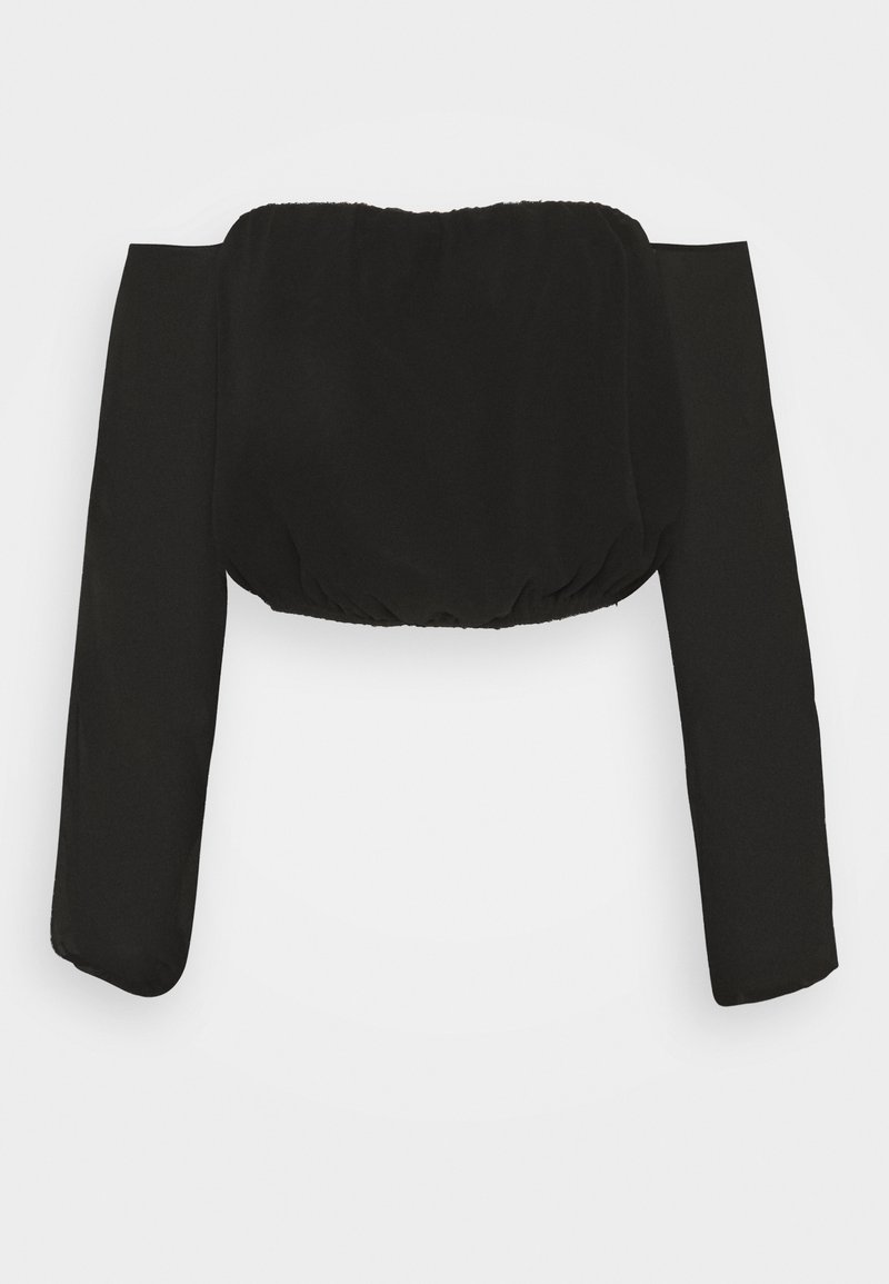 Svart kort topp med långa, puffiga ärmar, med ett elastiskt nackparti och nederkant för en figurnära look. Slätt, lätt tyg.