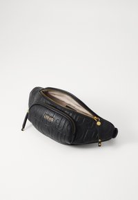 Schwarze, strukturiertes Lederhandtasche mit goldenen Beschlägen, betontem Logo, geschwungener Form und Reißverschlussfächern. Innen ist sie hell gefärbt.