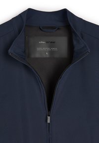 Granatowa kurtka do ćwiczeń z wysokim kołnierzem, pełnym zamszowym zapięciem z przodu oraz gładkim, elastycznym materiałem. Rozmiar L oznaczony wewnątrz.