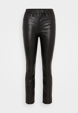 Black leather pants with a slim fit design. Features a zip fly and button closure, five-pocket styling, and smooth, shiny texture.