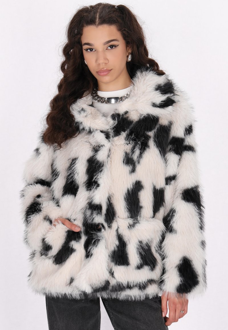 Black and white faux fur coat with an abstract pattern, featuring a plush texture, front pockets, and a collar.