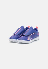 Purple athletic shoes with a smooth upper, pink accents, and contrasting white sole. Features a streamlined design and slip-on style.