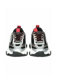 Chaussures de sport noires et argentées avec des accents rouges, dotées d'un dessus en maille, d'une semelle en caoutchouc épaisse et de détails métalliques sur les côtés.