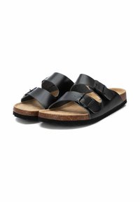 Sandalias deslizantes de cuero negro con dos correas ajustables, plantilla de corcho y suela de goma, que cuentan con un acabado suave y un diseño minimalista.