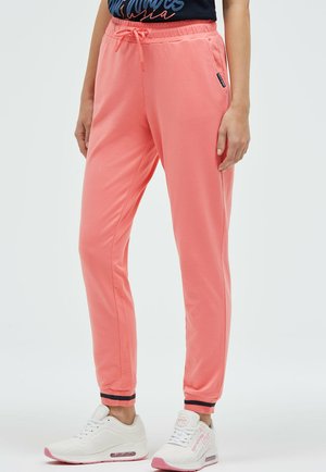 Korallfarbene Jogginghose mit elastischem Taillenbund und Kordelzug, ausgestattet mit Seitentaschen und eng anliegenden Bündchen mit kontrastierenden Details.